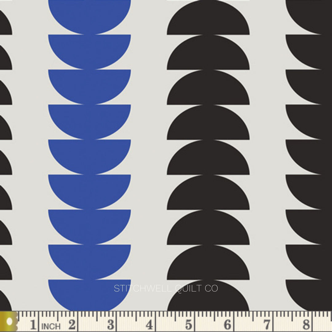 A repeating geometric pattern featuring vertical columns of stacked semi-circles in blue and black on a white background., with a measuring ruler along the bottom edge.